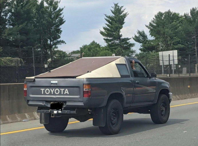 Picture of Cybertruck rolling off production line (or a Toyota pickup with pseudo cybertruck MDF styling)